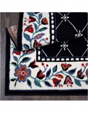 A black and white rug with flowers on it