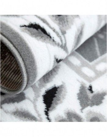 A close up of a rug with a black and white pattern on it.