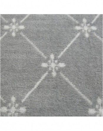A close up of a gray rug with white flowers on it.