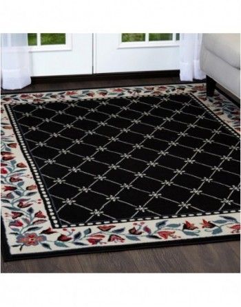 A black and white rug with a floral border