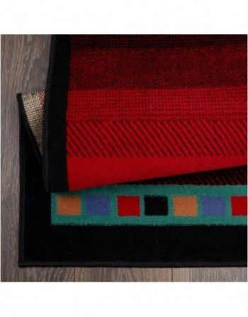 Three rugs are stacked on top of each other on a wooden floor.