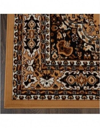 A rug with a floral pattern on it is on a wooden floor.