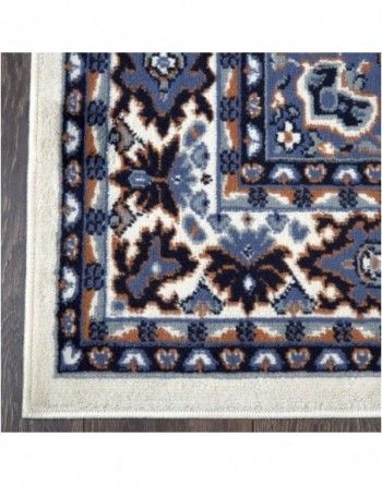 A close up of a rug on a wooden floor.