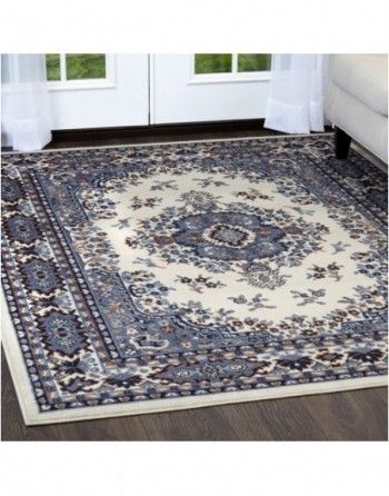 A blue and white rug is on the floor in a living room