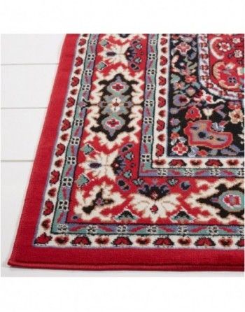 A red rug with a black and white pattern on it