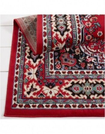 A red and black rug with a floral pattern on it