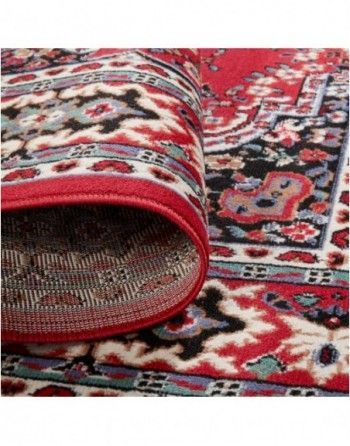A close up of a red rug with a floral pattern on it.