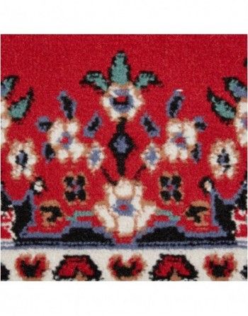 A red rug with a floral pattern on it