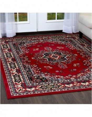 A red rug is on the floor in a living room