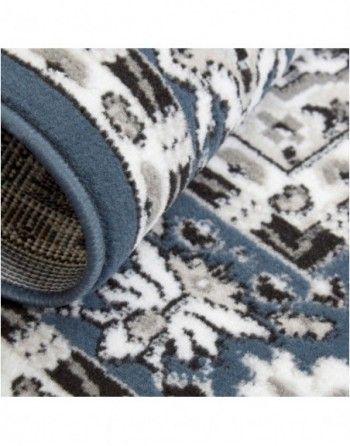 A close up of a blue and white rug with a pattern on it.
