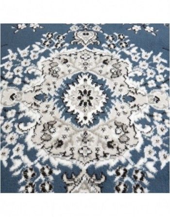 A blue and white rug with a floral pattern on it