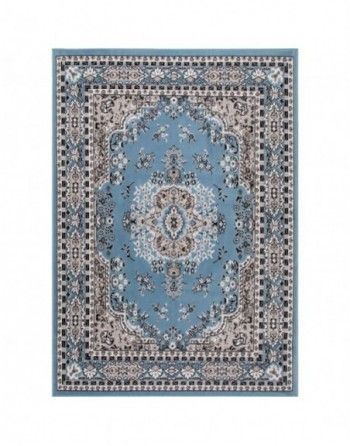 A blue rug with a pattern on it on a white background.