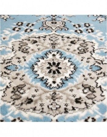 A blue and white rug with a floral pattern on it