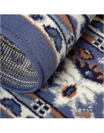 A close up of a blue and white rug with a pattern on it.
