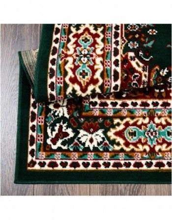 A green rug with a floral pattern on it