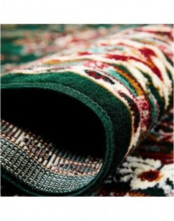 A close up of a rug with a green border