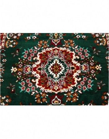 A green rug with a floral pattern on it