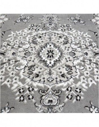 A gray and white rug with a circular pattern on it