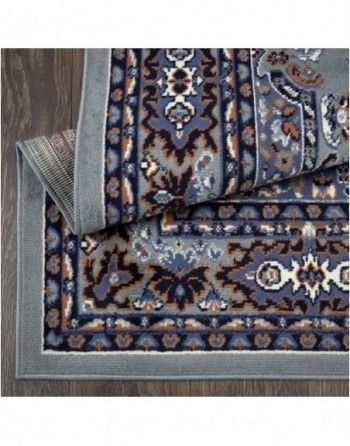 A close up of a rug on a wooden floor.