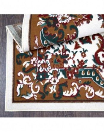 A rug with a floral pattern is laying on a wooden floor.