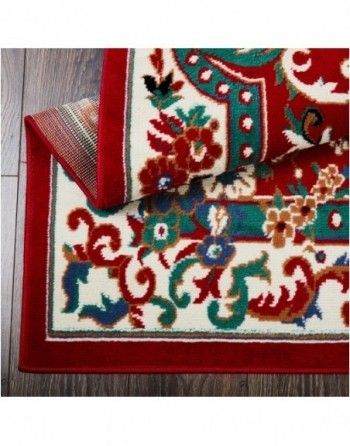 A red and white rug with a floral pattern on it