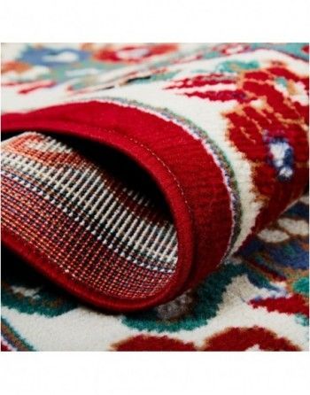 A close up of a rug with a red border