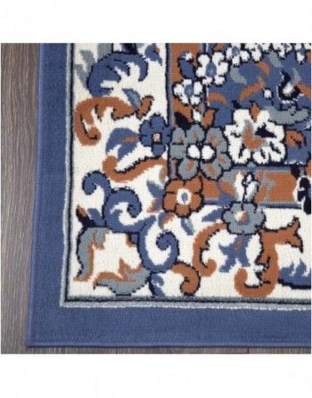 A rug with a blue border and flowers on it