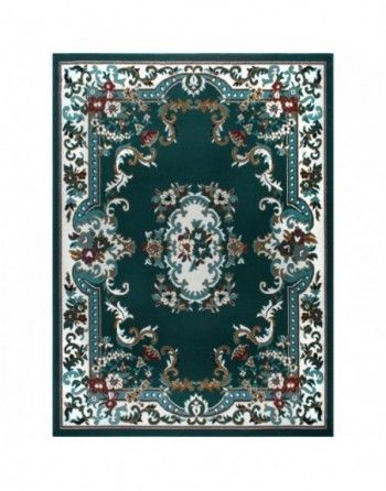 A green rug with a floral pattern on it