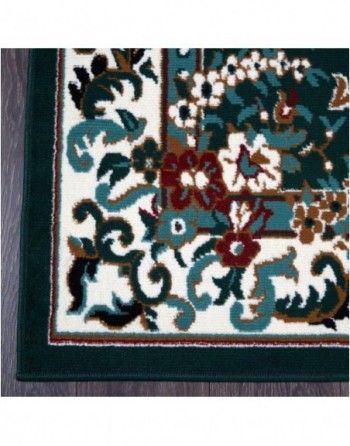 A green and white rug with flowers on it