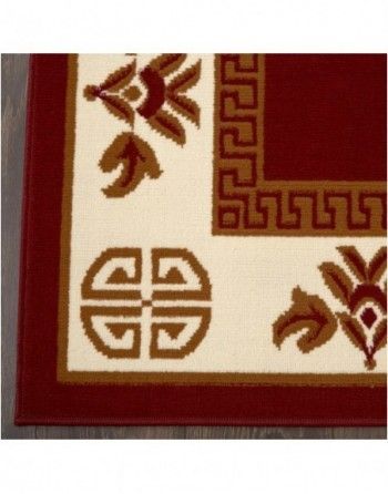 A red and white rug with a greek key design
