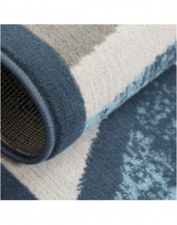 A close up of a blue and white rug with a pattern on it.