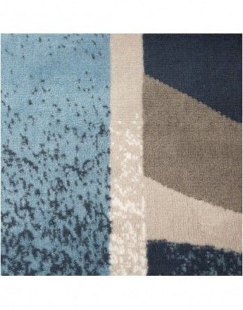 A close up of a blue and white rug with a geometric pattern