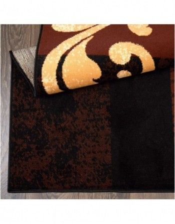 A brown and black rug with a gold pattern on it