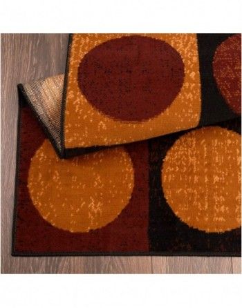 A rug with circles on it is sitting on a wooden floor.