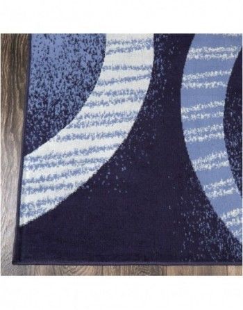 A blue and white rug is sitting on a wooden floor.