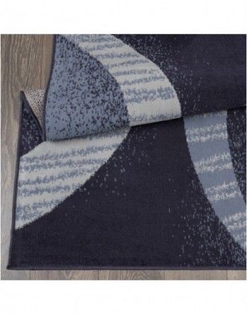 A blue and white rug is laying on a wooden floor.