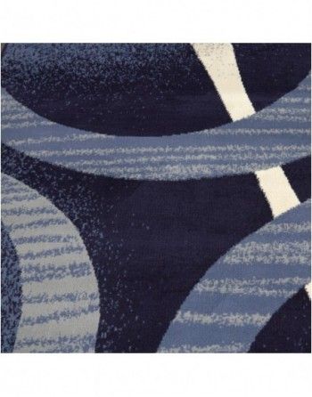 A close up of a blue and white rug with circles on it