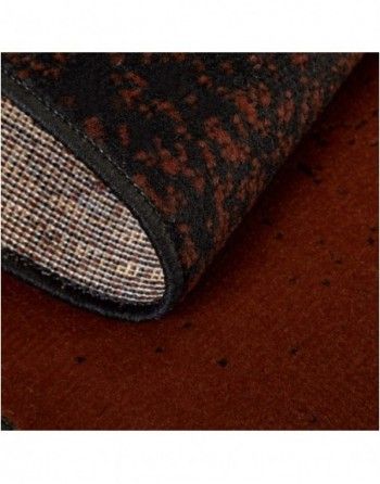 A close up of a brown rug with a black border