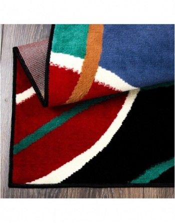 A colorful rug is laying on a wooden floor