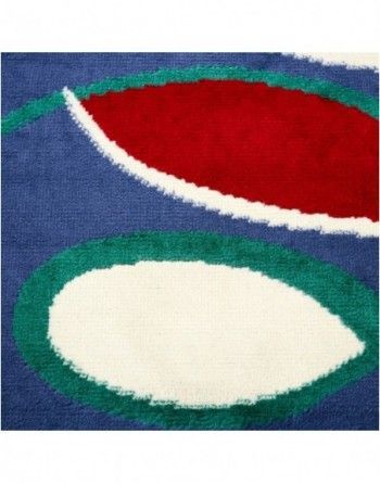 A close up of a colorful rug with circles on it.