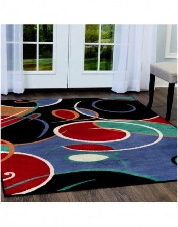 A living room with a colorful rug on the floor