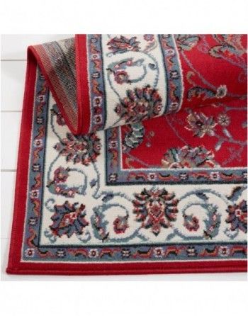 A red and white rug with a floral pattern on it