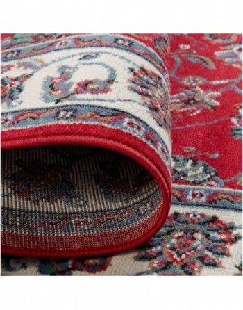 A close up of a red rug with a white border