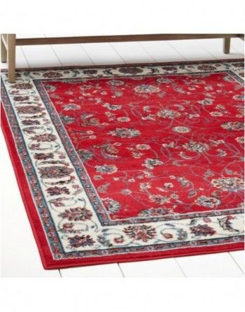 A red rug is on the floor next to a bench