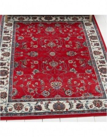 A red rug with a floral pattern on it