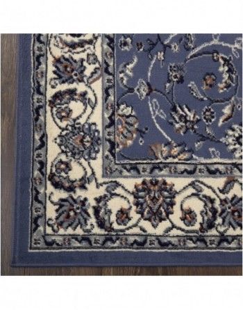 A blue and white rug with a floral pattern on it