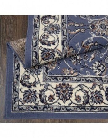 A blue and white rug is laying on a wooden floor