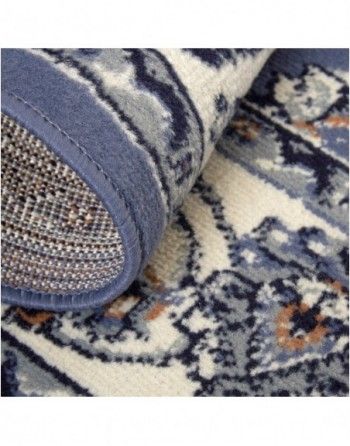 A close up of the bottom of a blue and white rug.