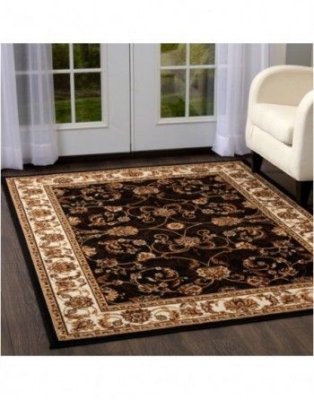 A living room with a chair and a rug on the floor