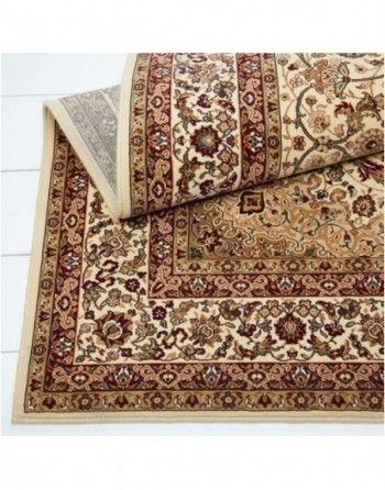 A rug with a floral pattern is rolled up on a table.